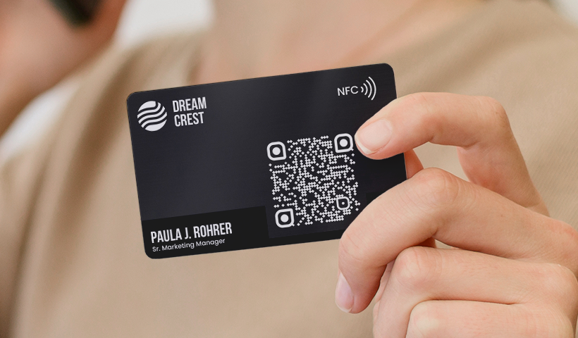 Black NFC business card with a QR code held in hand.